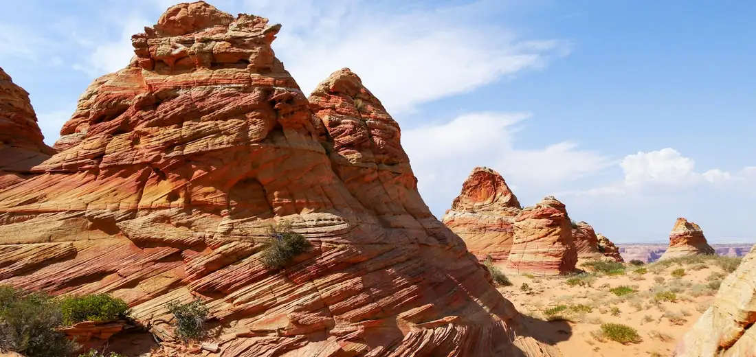 Desert rock formations in an arid landscape under a blue sky