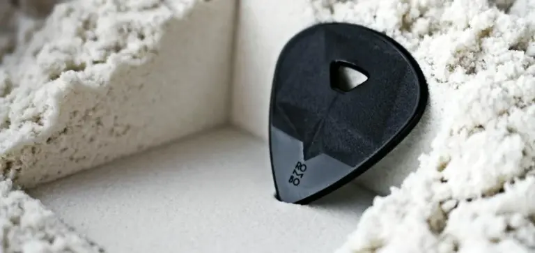 Small black plastic object partially embedded in a mound of white powdery substance