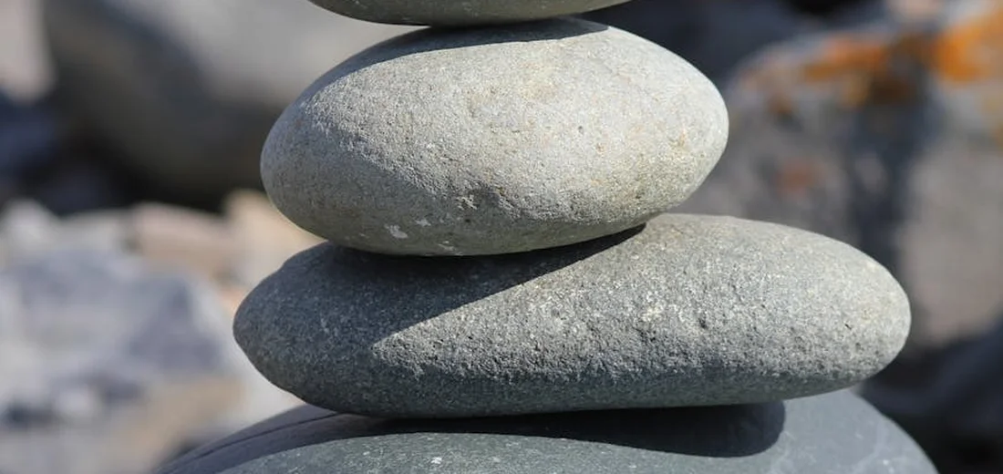 Stack of smooth gray pebbles balanced on top of each other